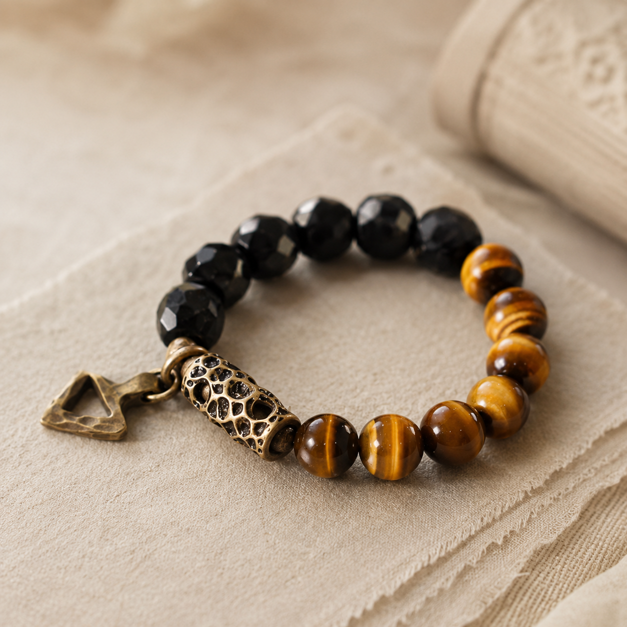 Tiger eye and faceted black obsidian bracelet with bronze accents on linen